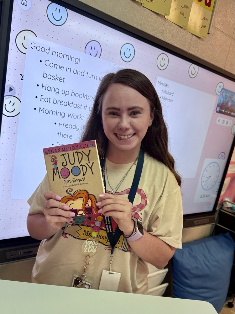 teacher holding Judy bloom book