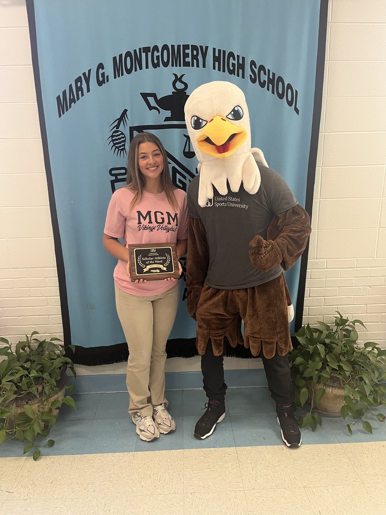 Gracelynn Dew of Mary G. Montgomery stands  with the U.S. Sports University's eagle mascot