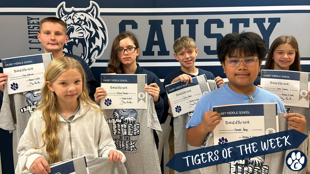 Group of students holding t-shirts and certificate