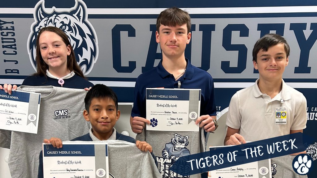 Group of students holding t-shirts and certificates