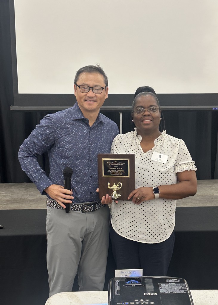 James Taylor in picture with Keisha Mack holding Award at 2025 Alabama Library EXPO. 