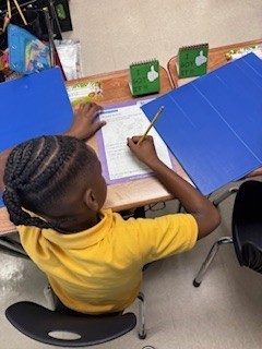 A male student writes predictions on his paper