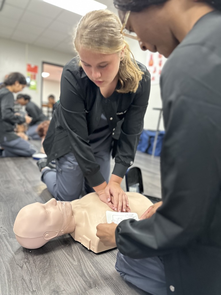 A student performing CPR on a mannekin