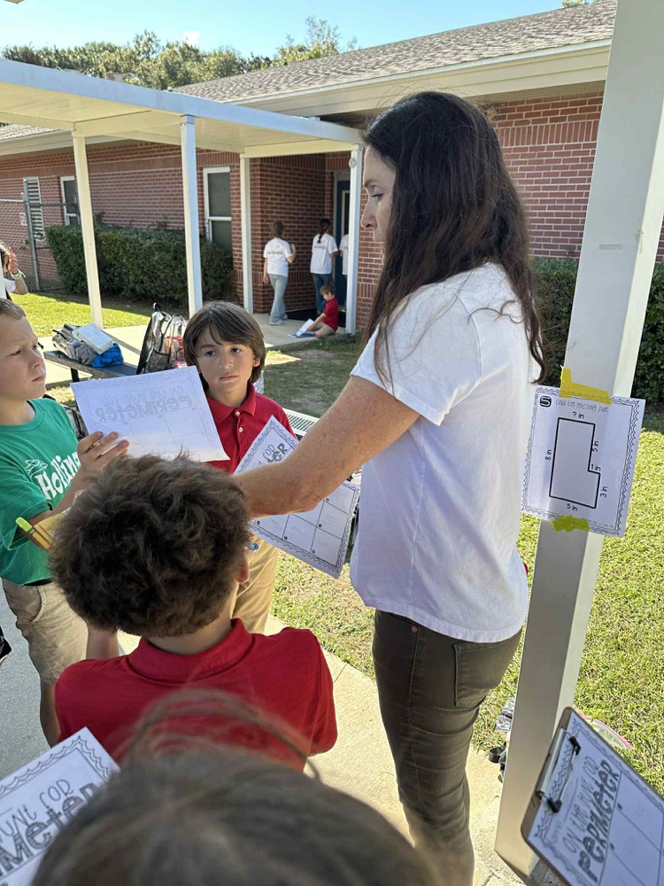 Teacher and student outside doing math problems.