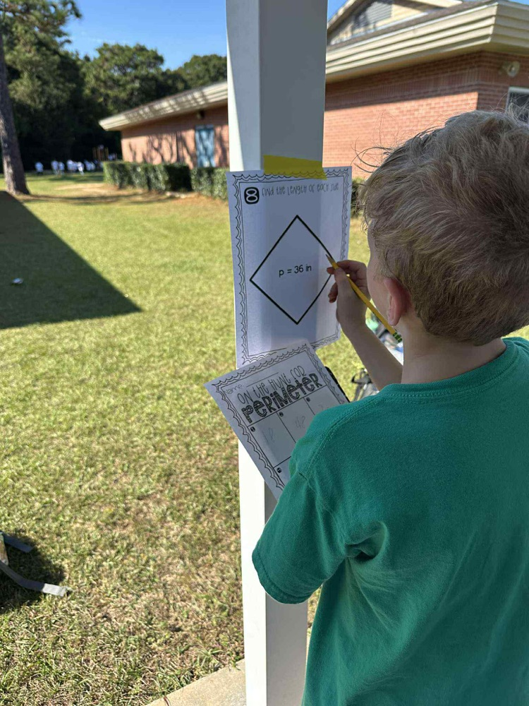 student outside doing math problems
