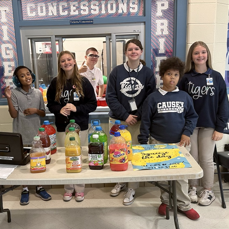 Group of students at a table with juice