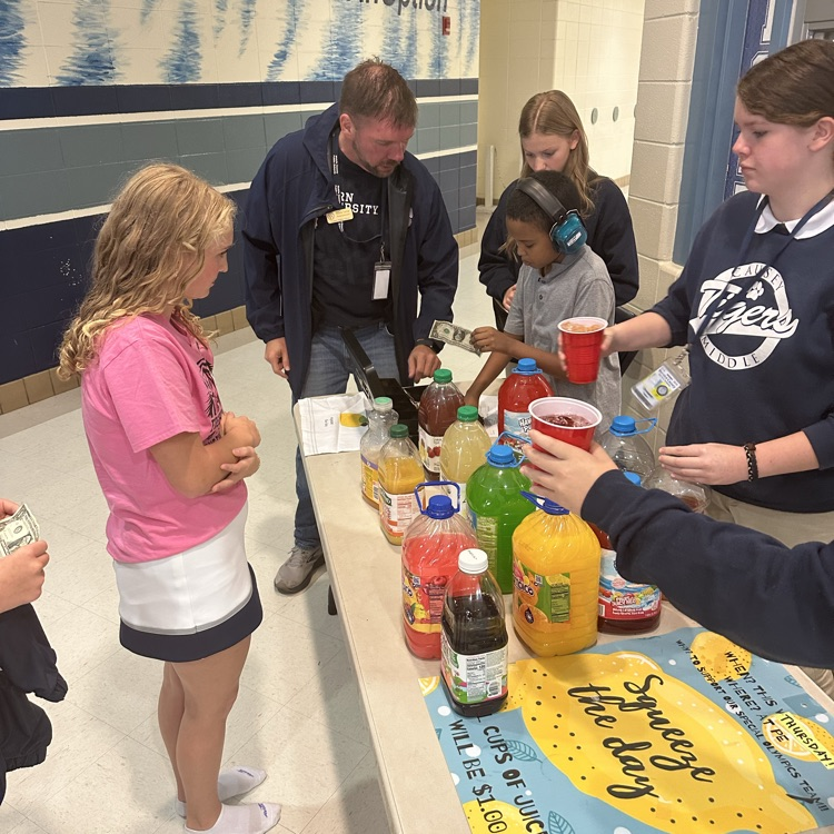 Group of students selling & buying juice