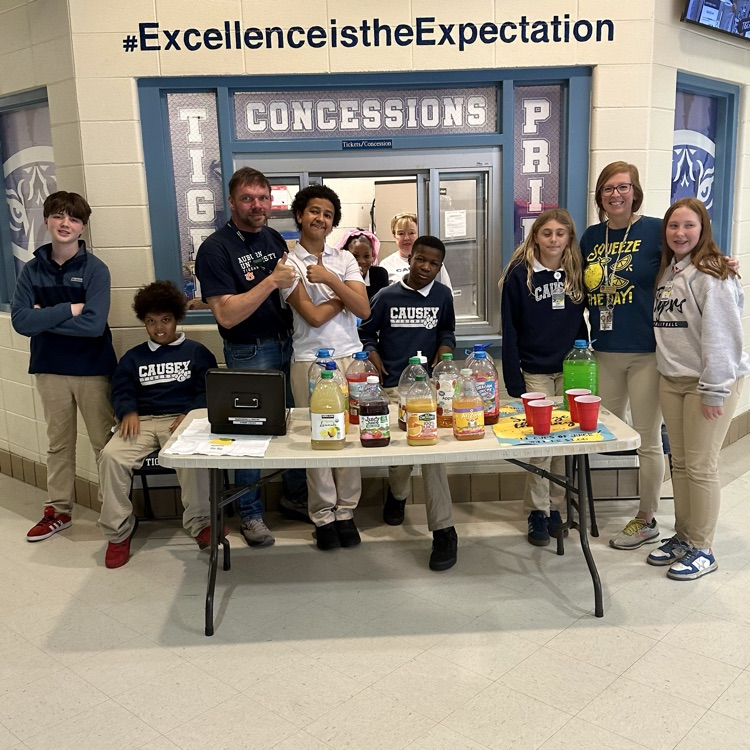 Group of students at a table with juice