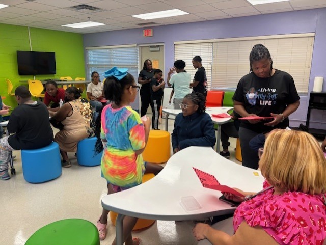 Students and parents play math games together.