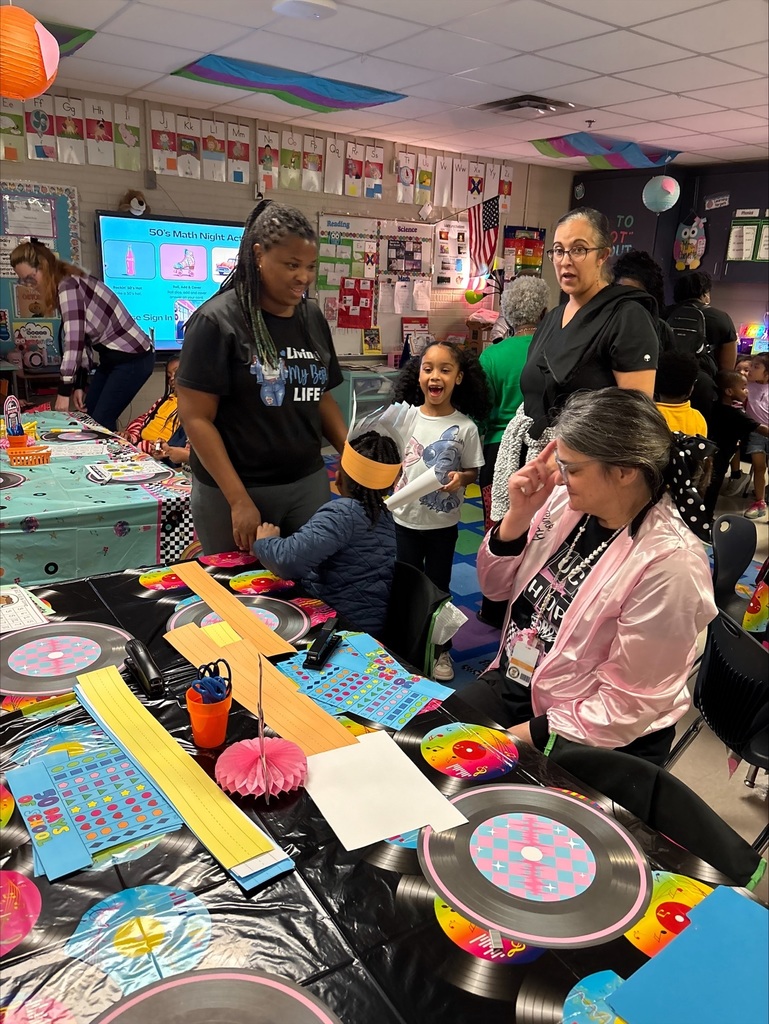1st grade students and parents play math games together.