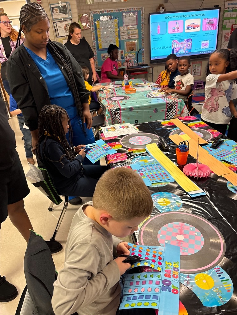 Students and parent play math games together.
