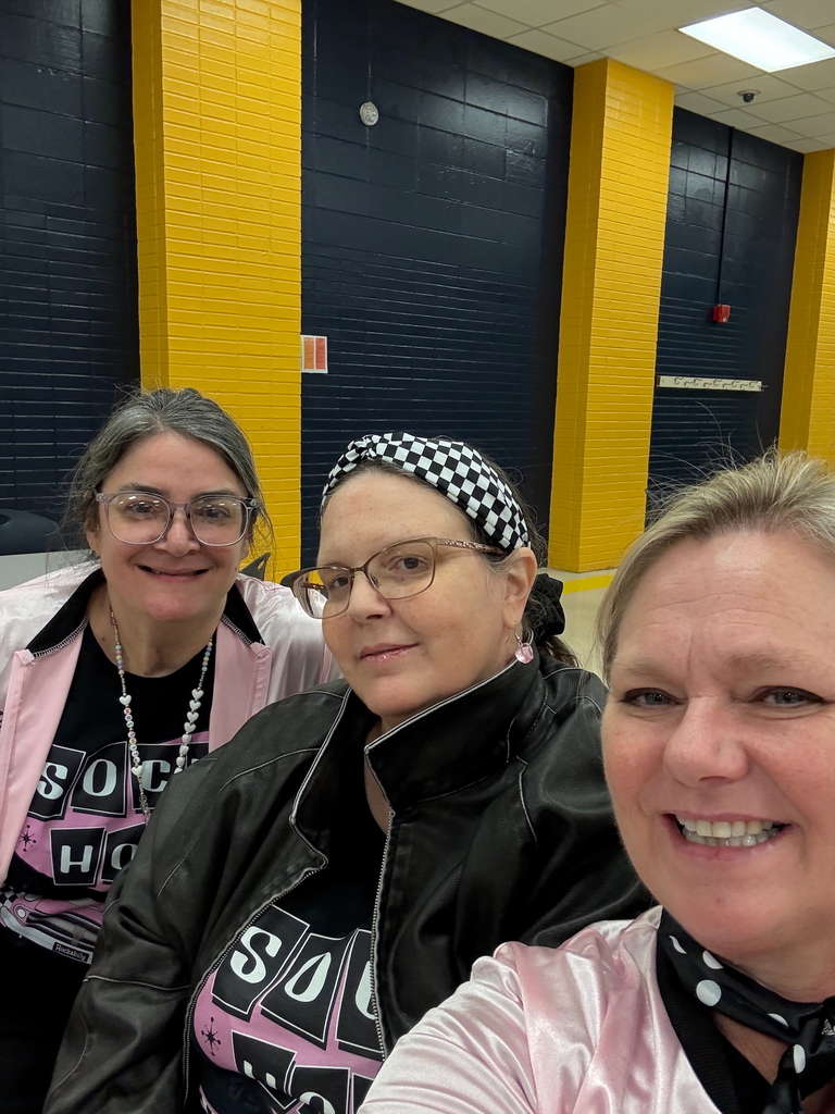 Three teachers wearing 50's themed jackets