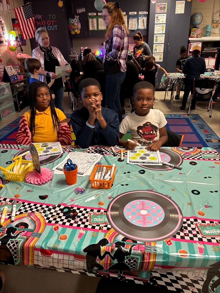 three students pose for a picture during math night