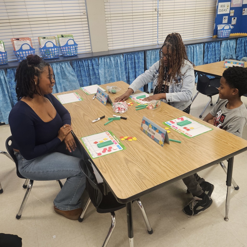 A teacher, parent, and student play a math game together.