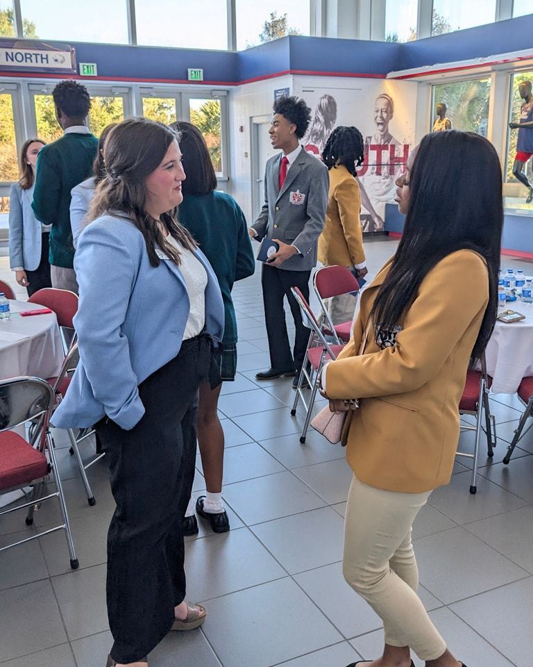 MGM Academy Ambassador speaking with an Ambassador from another school.