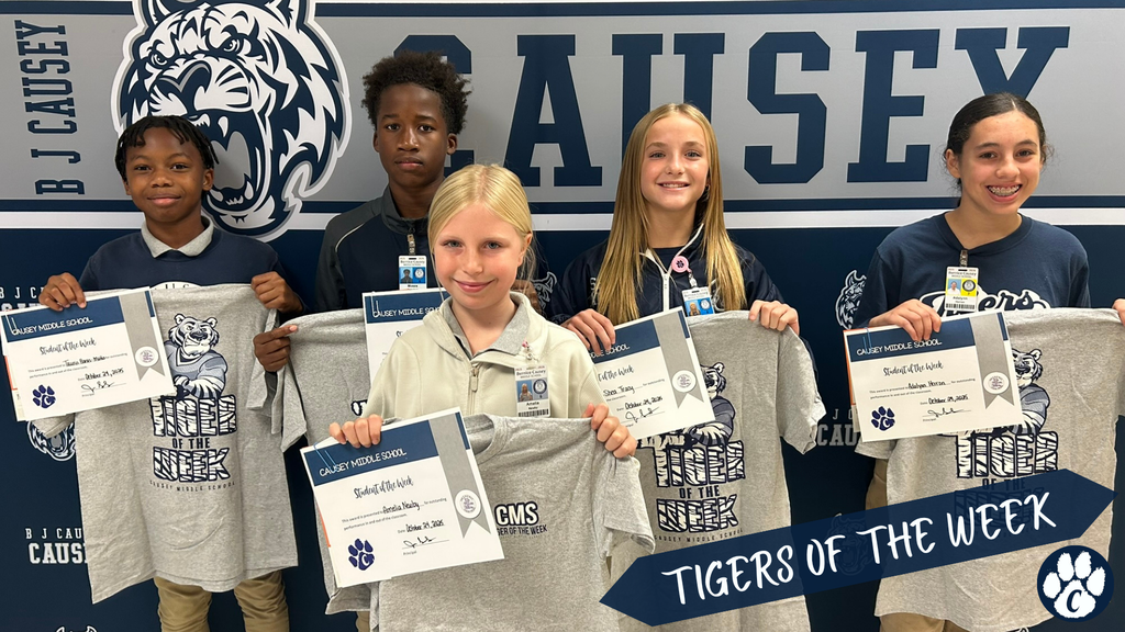 Group of students holding t-shirts and certificate