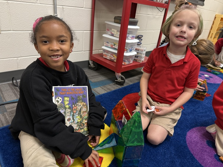 students building a house with magnet tiles