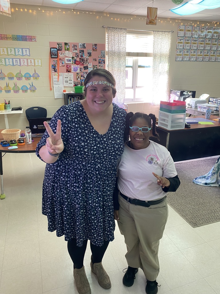 Teacher with student in classroom