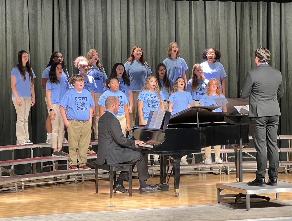 A choir with a director and pianist