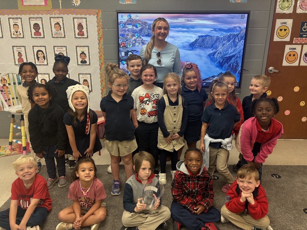 teacher standing with students