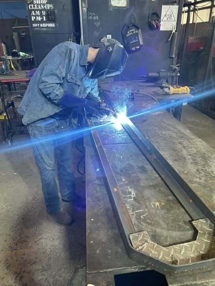 Welding students making benches