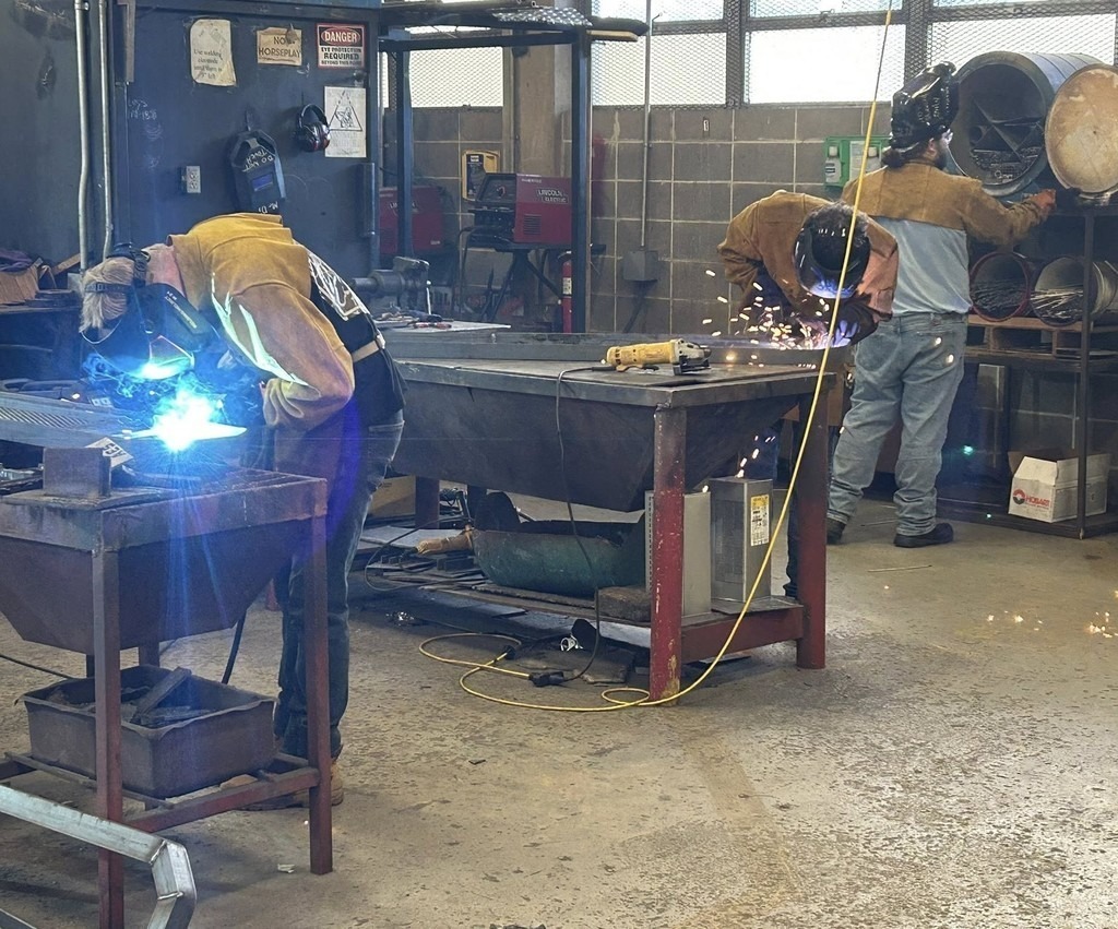 Welding students making benches