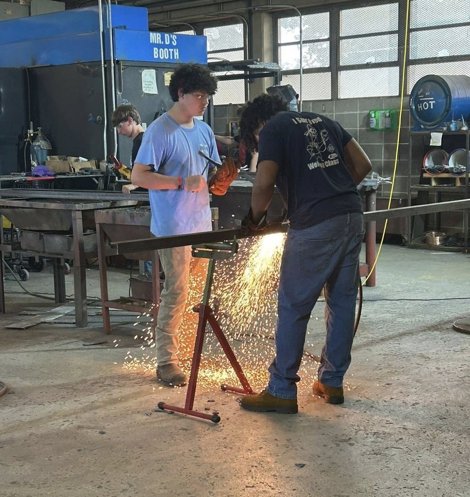 Welding students making benches