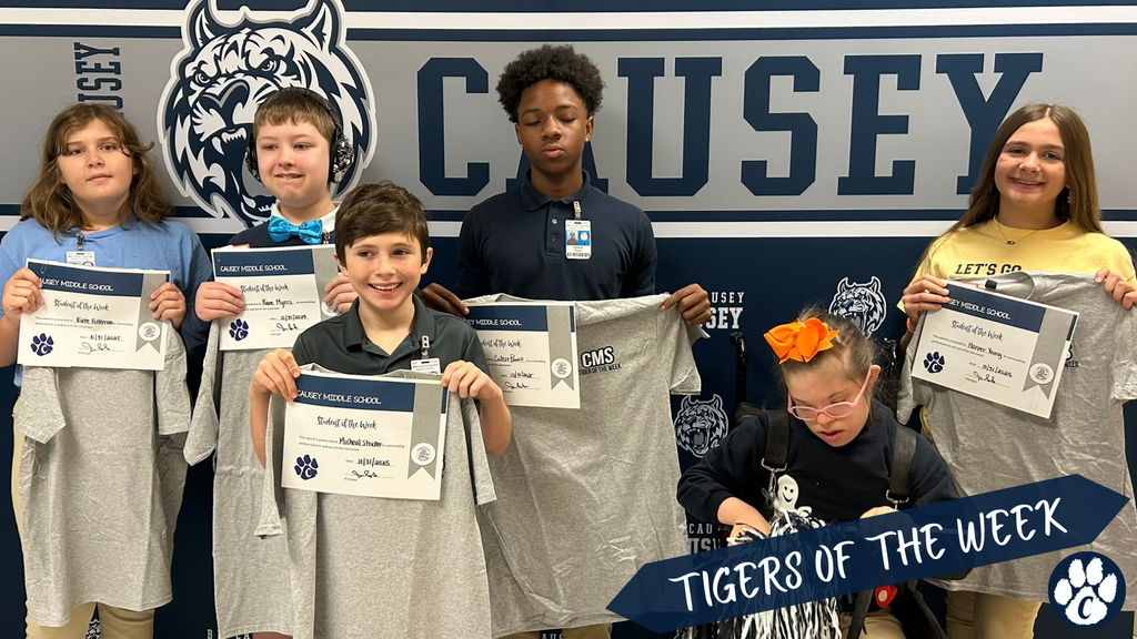 Group of students holding t-shirts and certificate