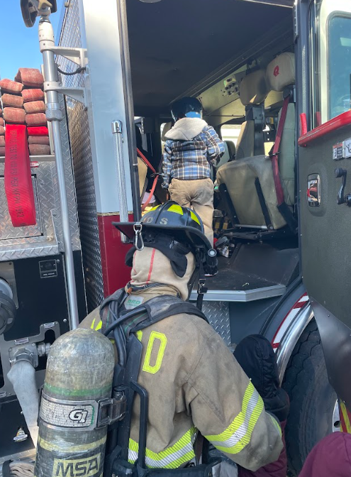Students climbing in a fire truck