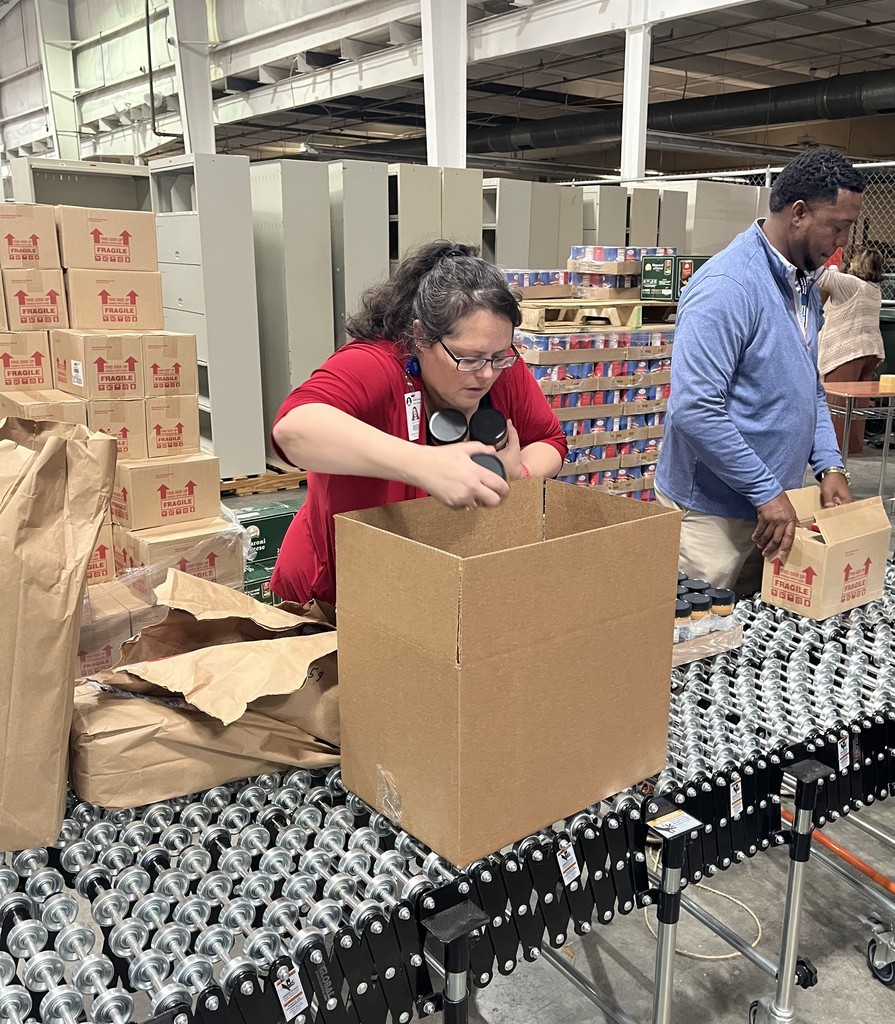 A woman putting food into a box