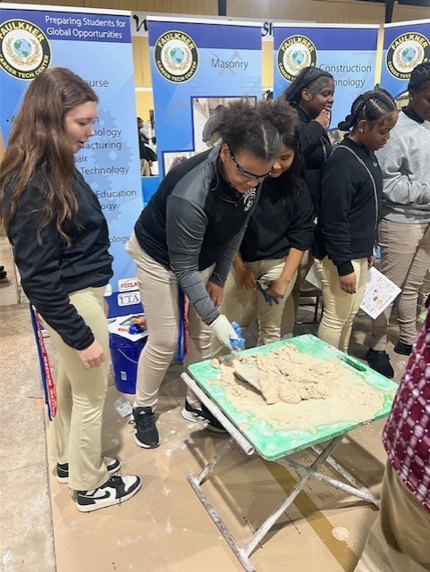 Middle School students doing hands on masonry activity