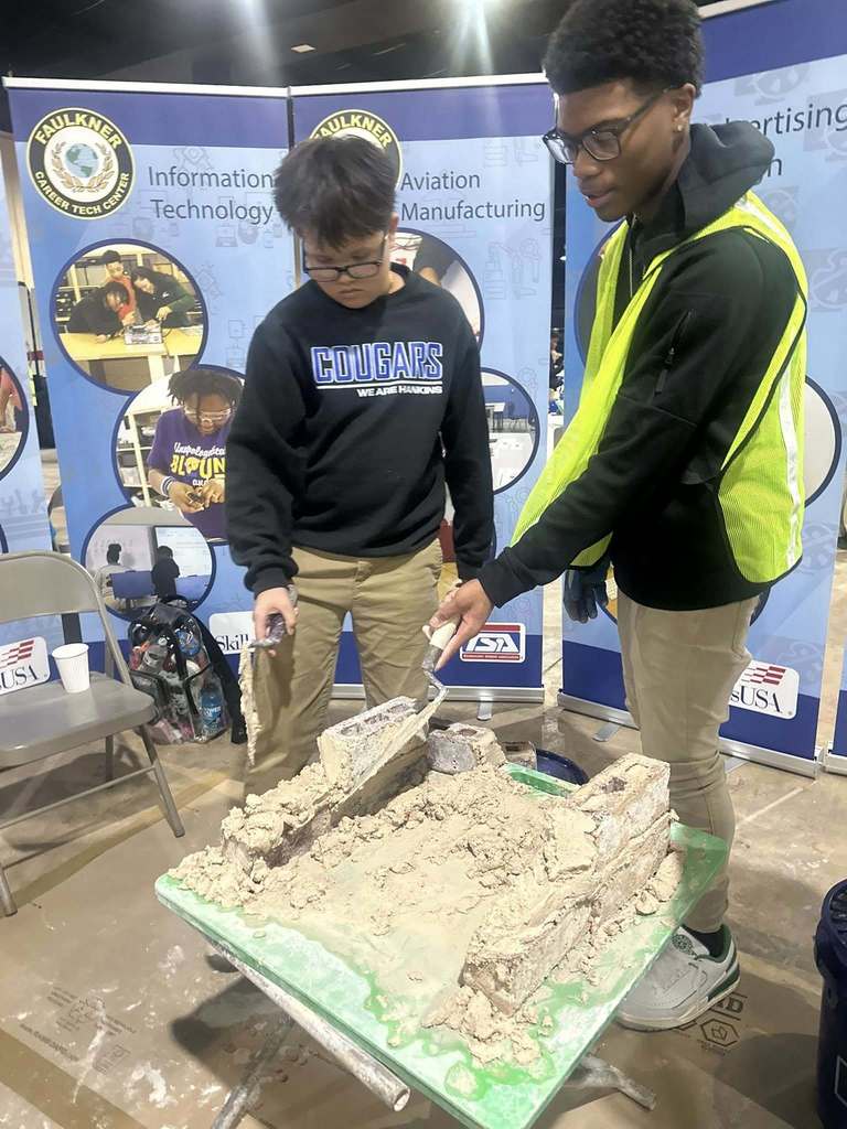 Masonry students assisting middle school students with demo