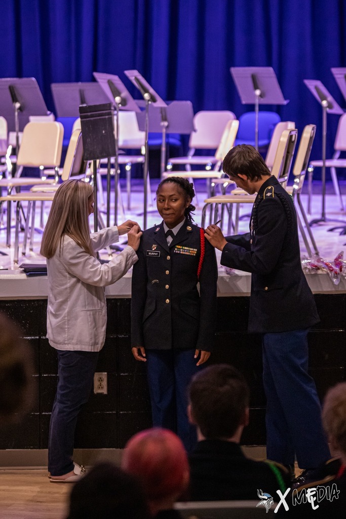 Cadets received their new cords and pins with the help of Assistant Principal, Ms. Box.