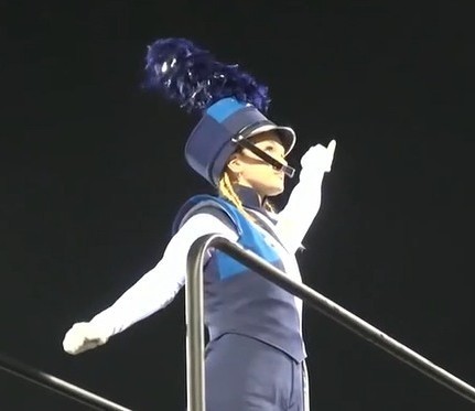 A drum major in a blue uniform