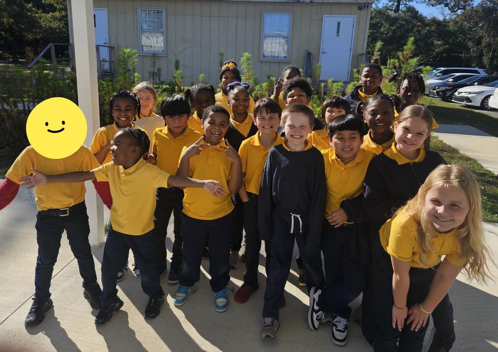 Ms. Baker's 3rd grade class near the school pollinator garden
