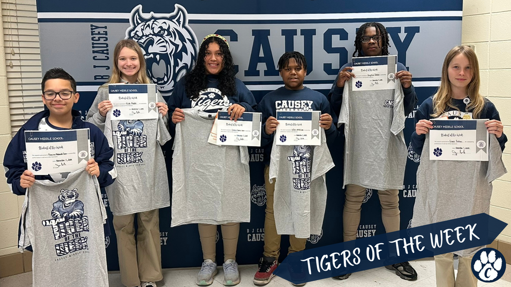 Group of students holding t-shirts and certificate