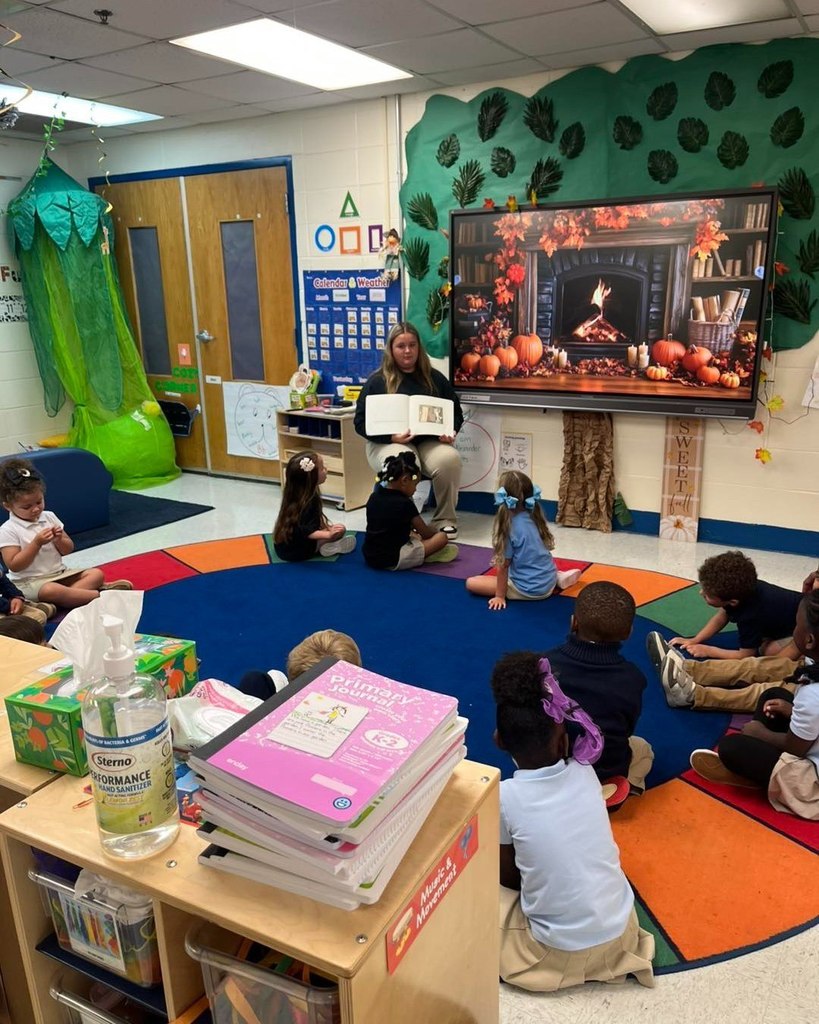 Pre-K students being read to by MGM student