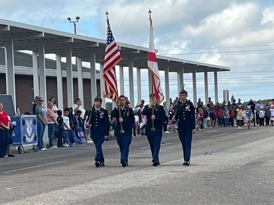 JROTC students marching with flags