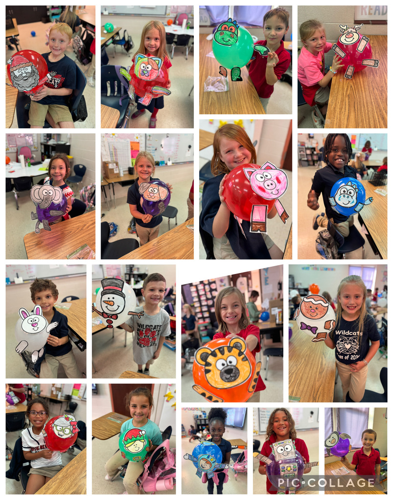 students holding decorated balloons