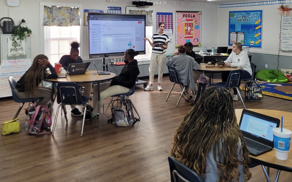 An educator speaking in front of a classroom of students