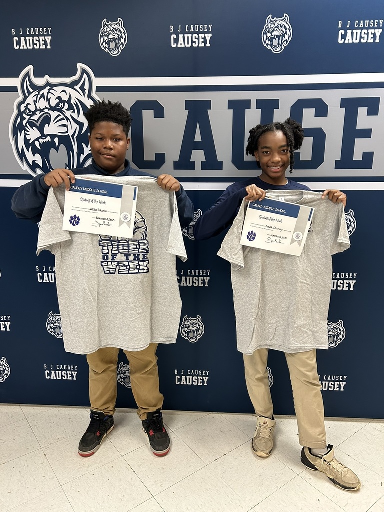 2 students holding up t-shirts and certificates, Tiger of the Week 11-21