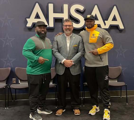 Two football coaches with the AHSAA Executive Director