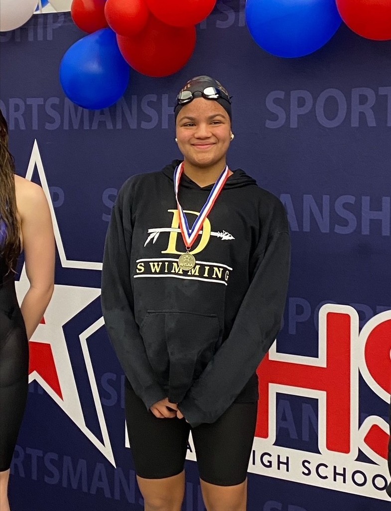 Davidson High swimmer Peyton Williams, in a swim cap and goggles with a medal around her neck