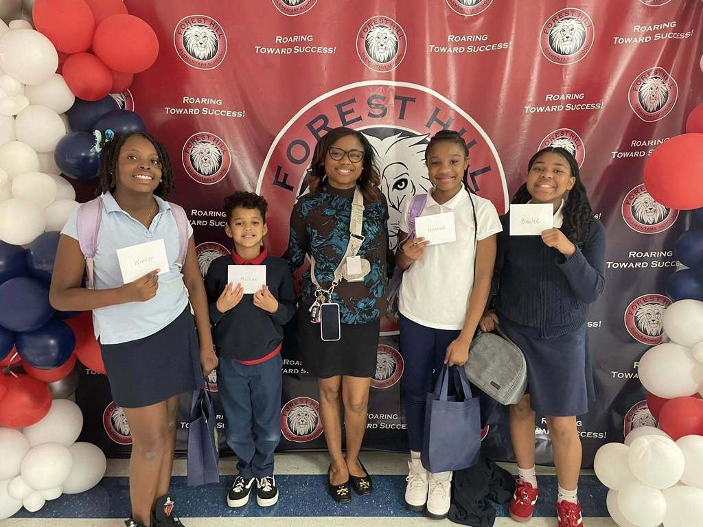 A teacher and four students holding envelopes
