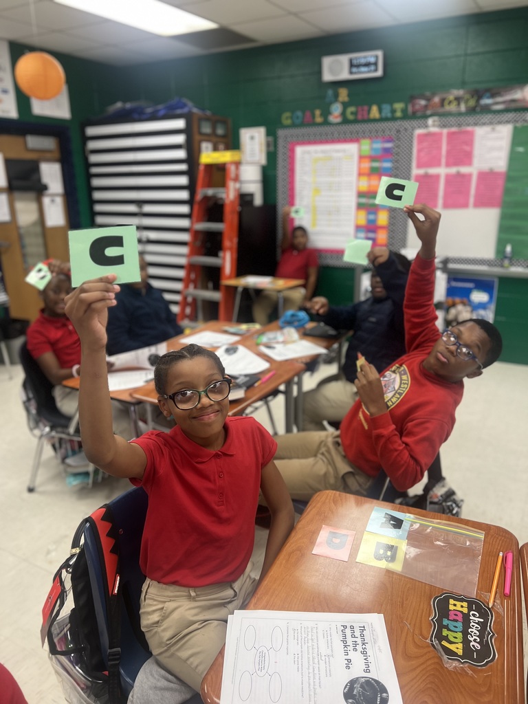 Ms. Colston's Class discussing a Thanksgiving passage and eating pumpkin pie. 