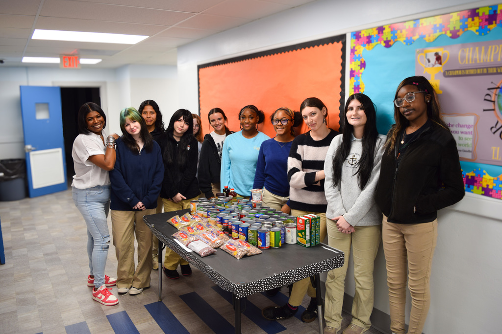 Cosmetolegy Instructor and Students next to food drive