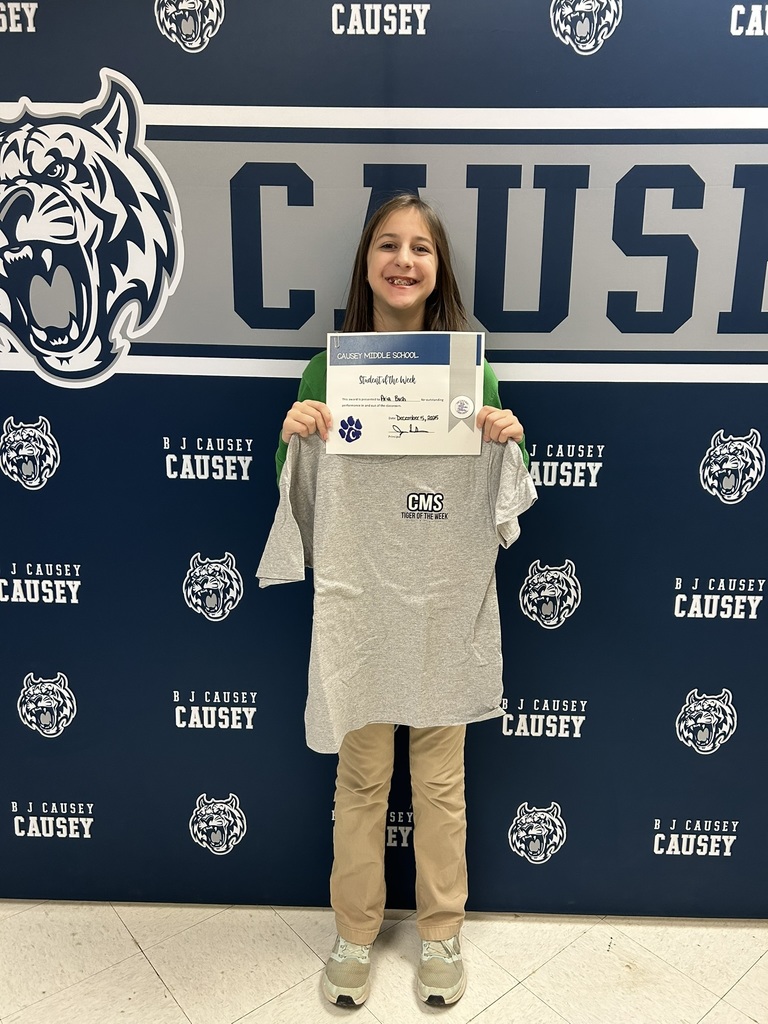 Student holding t-shirt and certificate