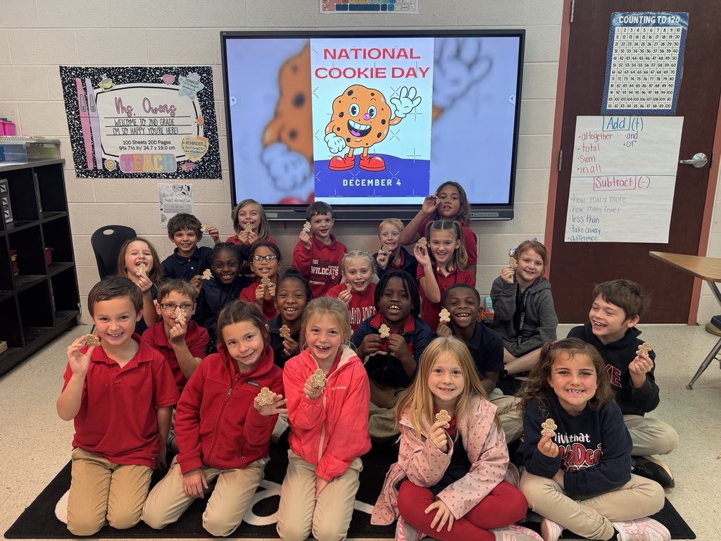 Students posing with a gingerbread