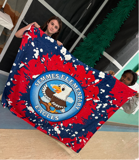 two girls holding eagle blanket