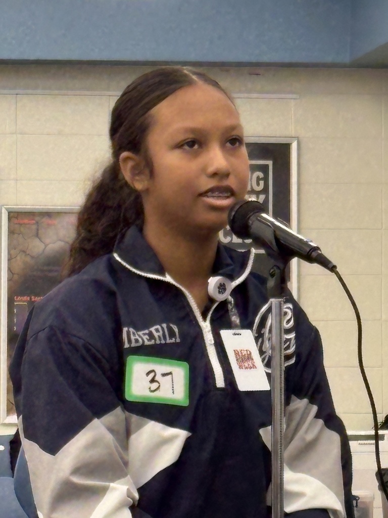 Girl standing at a microphone.